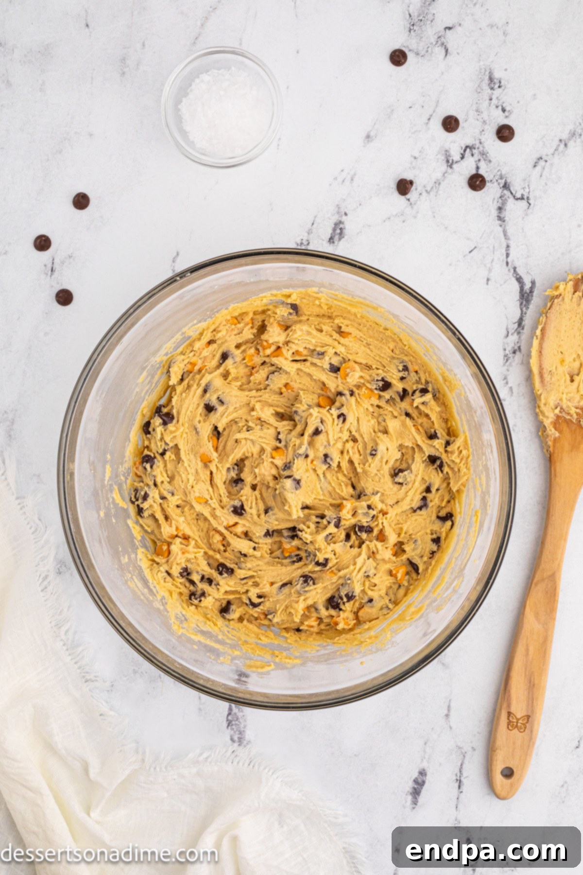 Chocolate chips and butterscotch chips lightly folded into the cookie dough by hand to prevent overmixing.