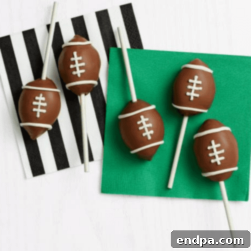 Game-Day Football Cake Pops dipped in chocolate with white icing.
