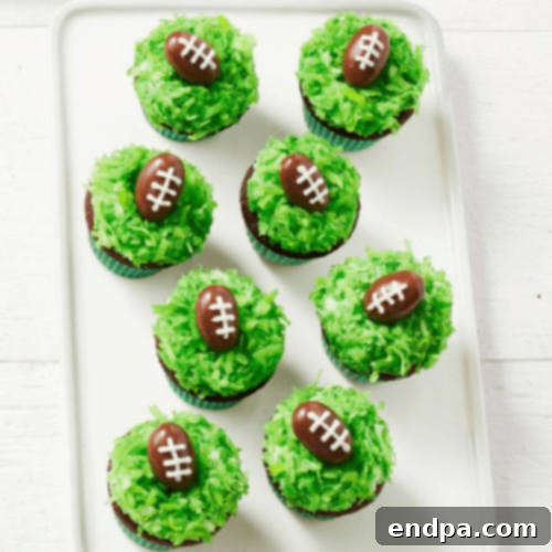 Mini cupcakes decorated with green coconut and almond footballs.