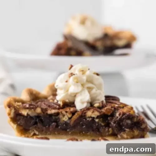 32 Christmas Pie Delights 8 A rich slice of Chocolate Pecan Pie, a classic Southern dessert with a twist.