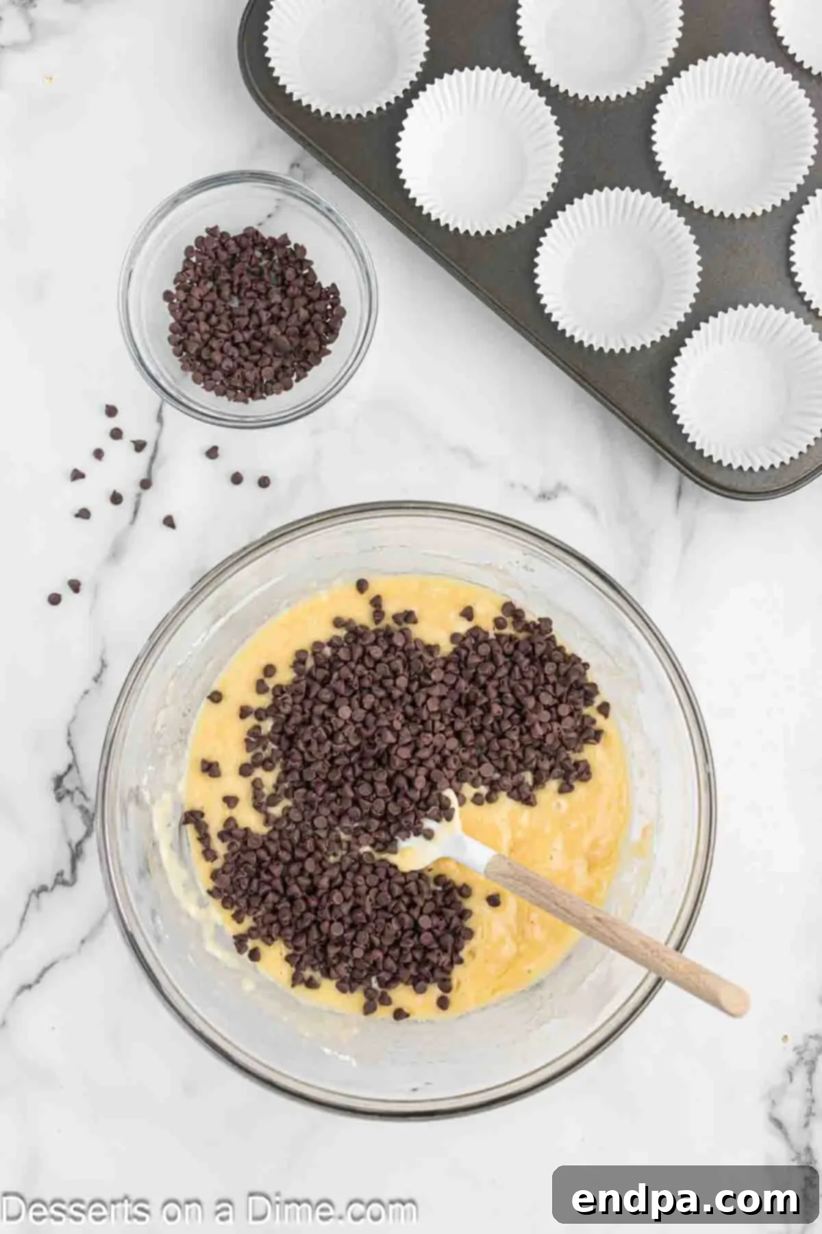 Decadent Chocolate Chip Cupcakes 7 Chocolate chips added to bowl.