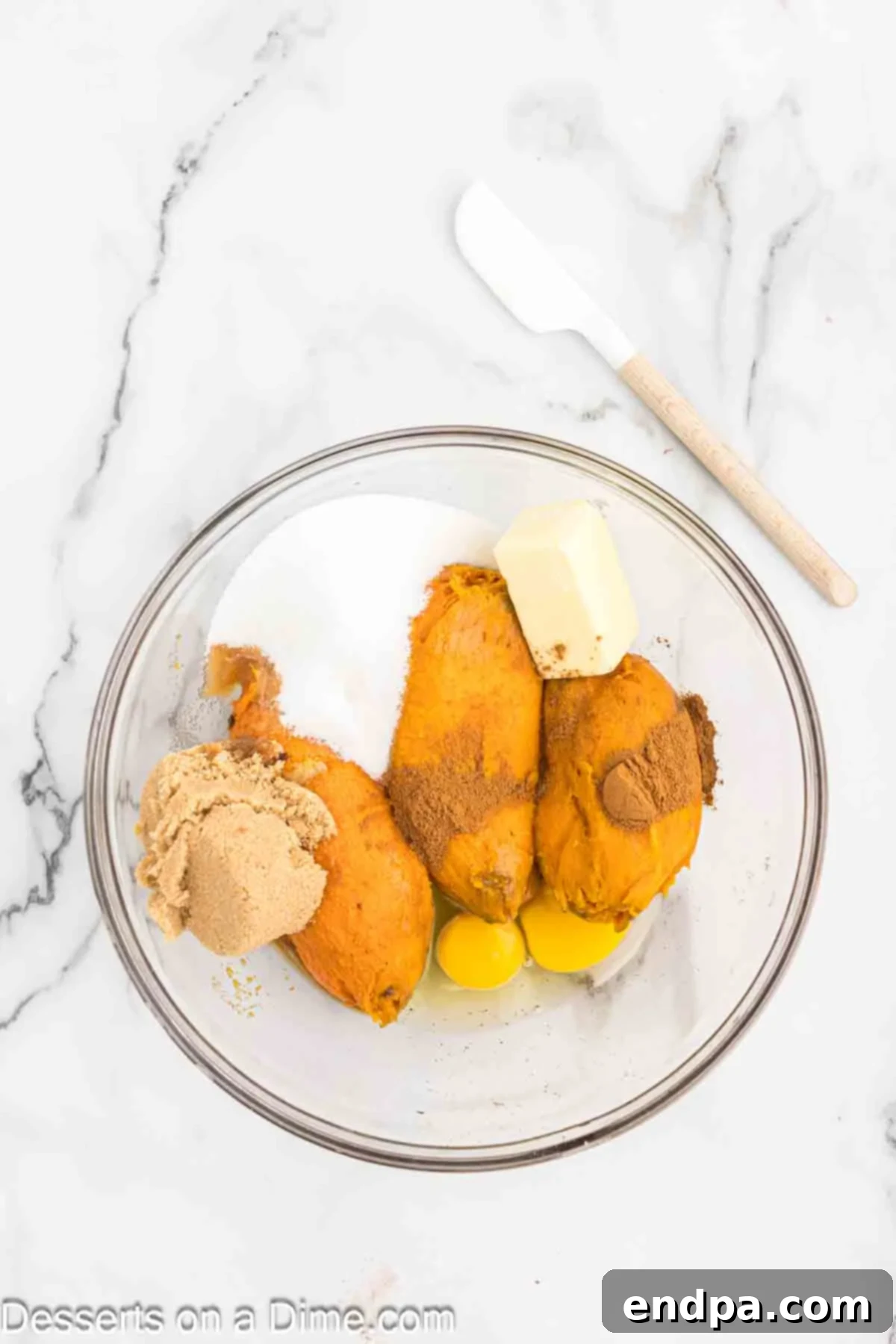 Velvety Sweet Potato Pecan Delight 4 Mixing bowl with sweet potatoes, eggs and sugar, ready to be combined.