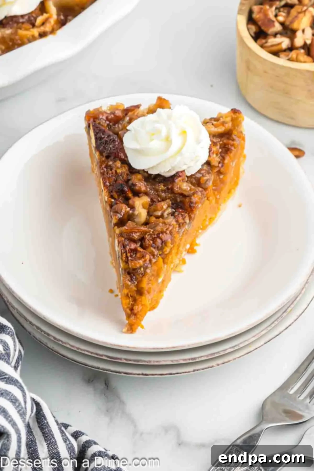 Velvety Sweet Potato Pecan Delight 8 Slice of sweet potato pecan pie on a plate, showcasing the layers.