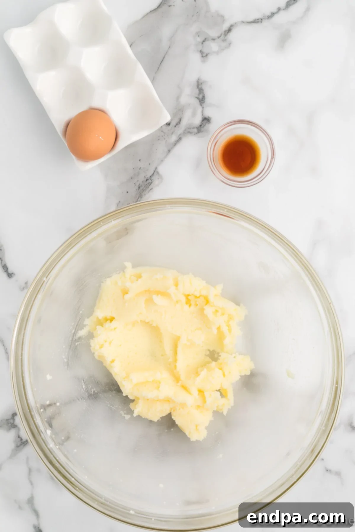 Sizzling Indulgences 5 Softened butter and granulated sugar creamed together in a mixing bowl.