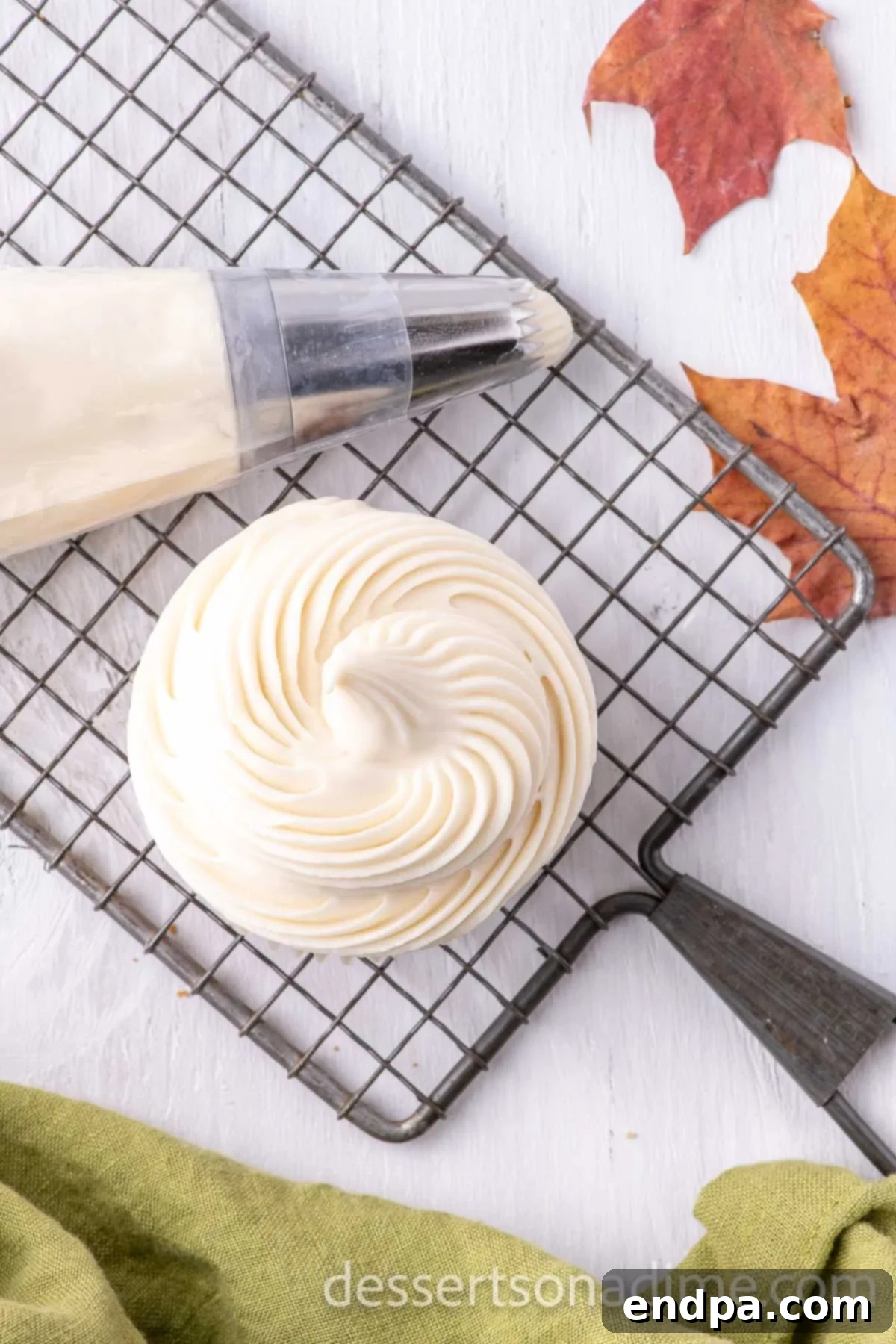 Velvety Maple Cream Cheese Frosting 7 Maple Cream Cheese Frosting piped on to a cupcake.