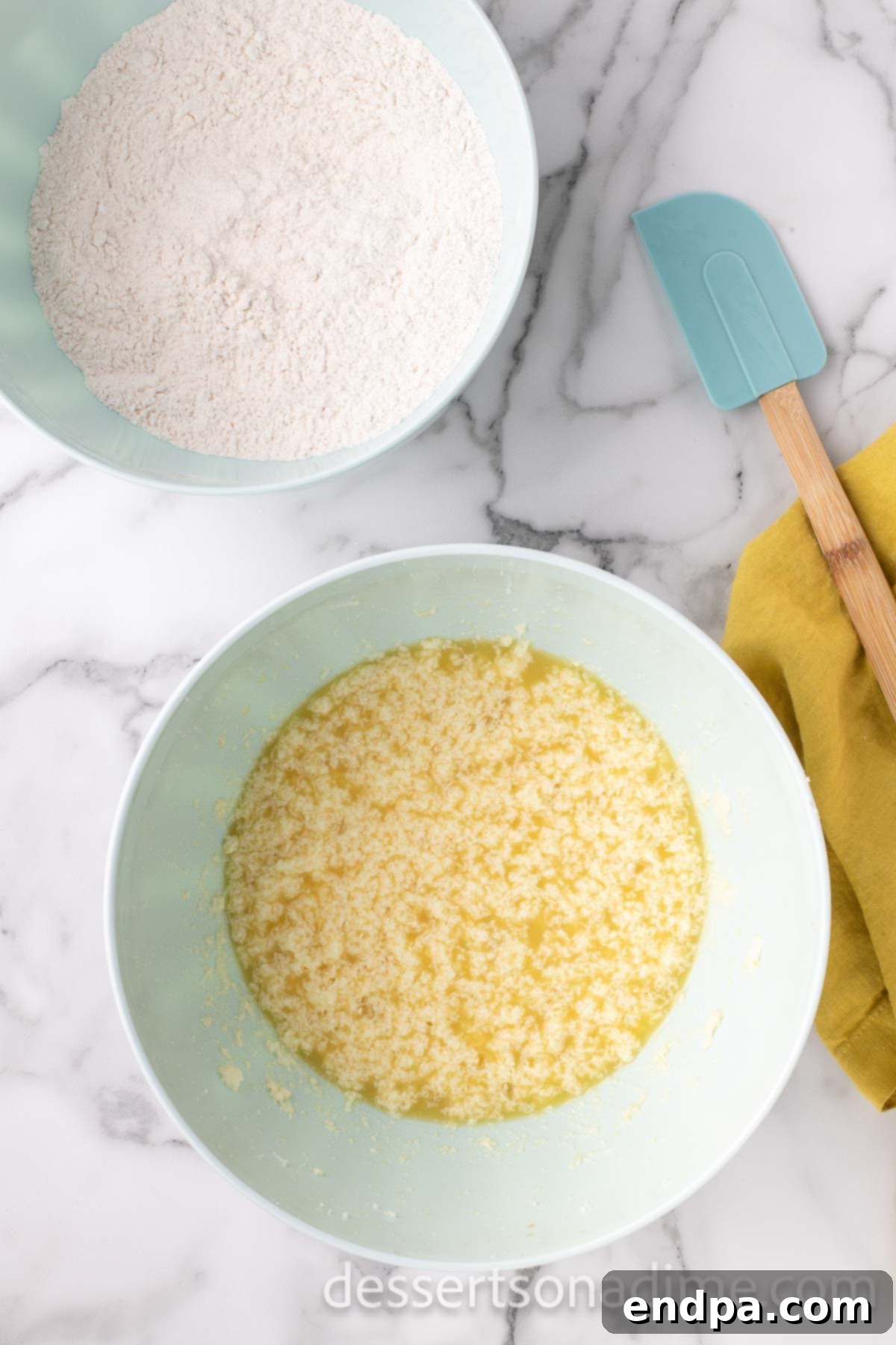 A separate mixing bowl showcasing the wet ingredients: softened butter, granulated sugar, and eggs, creamed together.