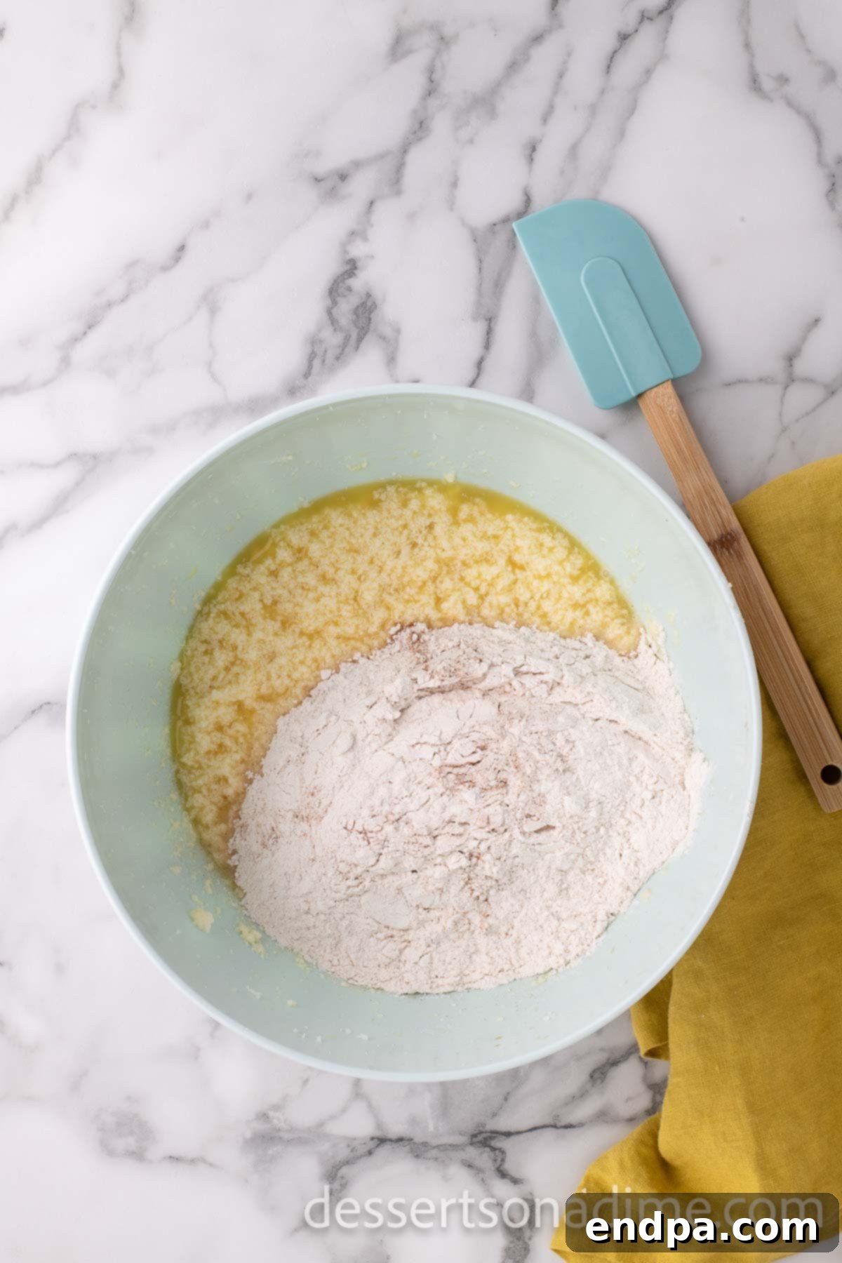 A mixing bowl where wet and dry ingredients have just been combined to form the cupcake batter.