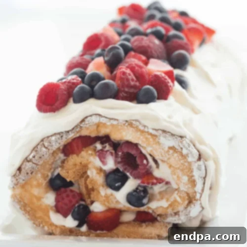 Triple Berry Angel Food Cake Roll, an easy red, white, and blue dessert with fresh summer berries.