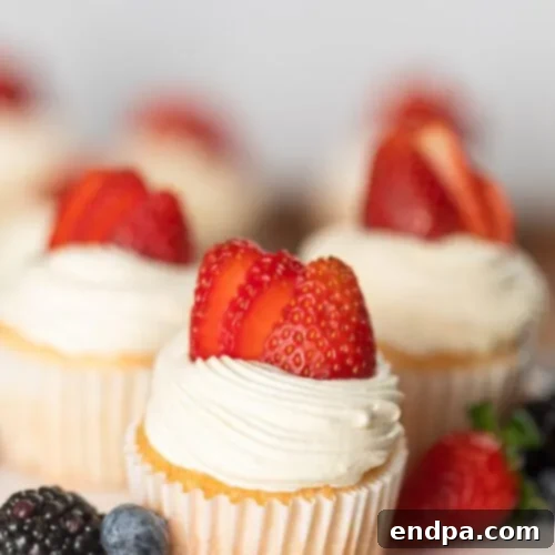 Delightful Angel Food Cupcakes topped with fresh strawberries, a light and easy treat.