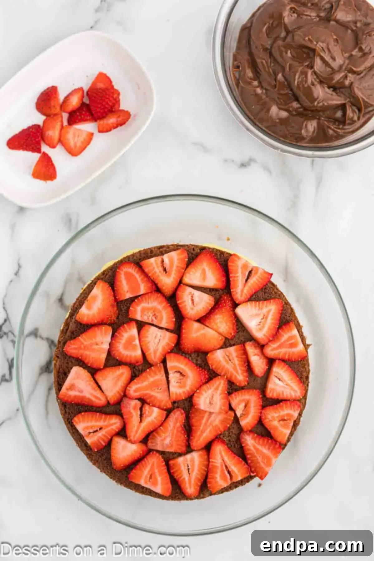 The Ultimate Atomic Cake 7 Strawberry slices on cake.