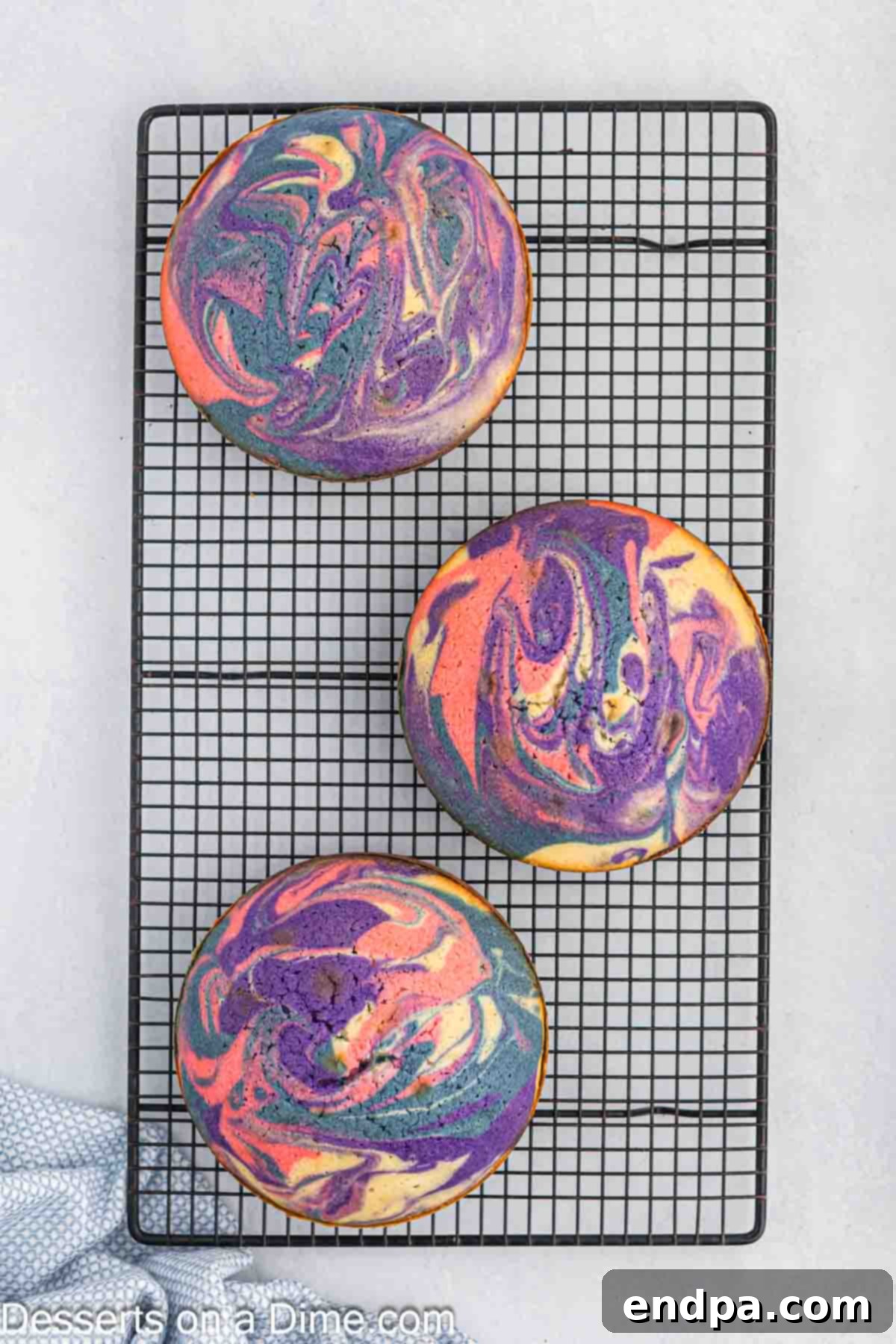 Baked cake layers cooling on wire racks.