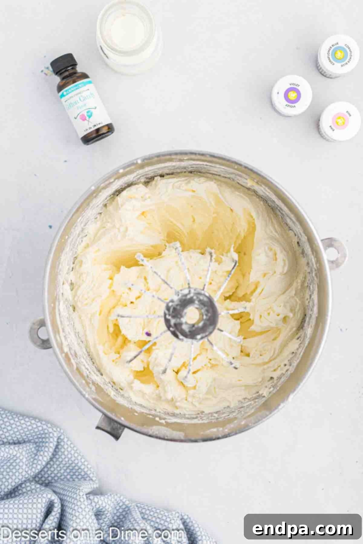 Frosting mixture combined together in a large mixing bowl, looking light and fluffy.