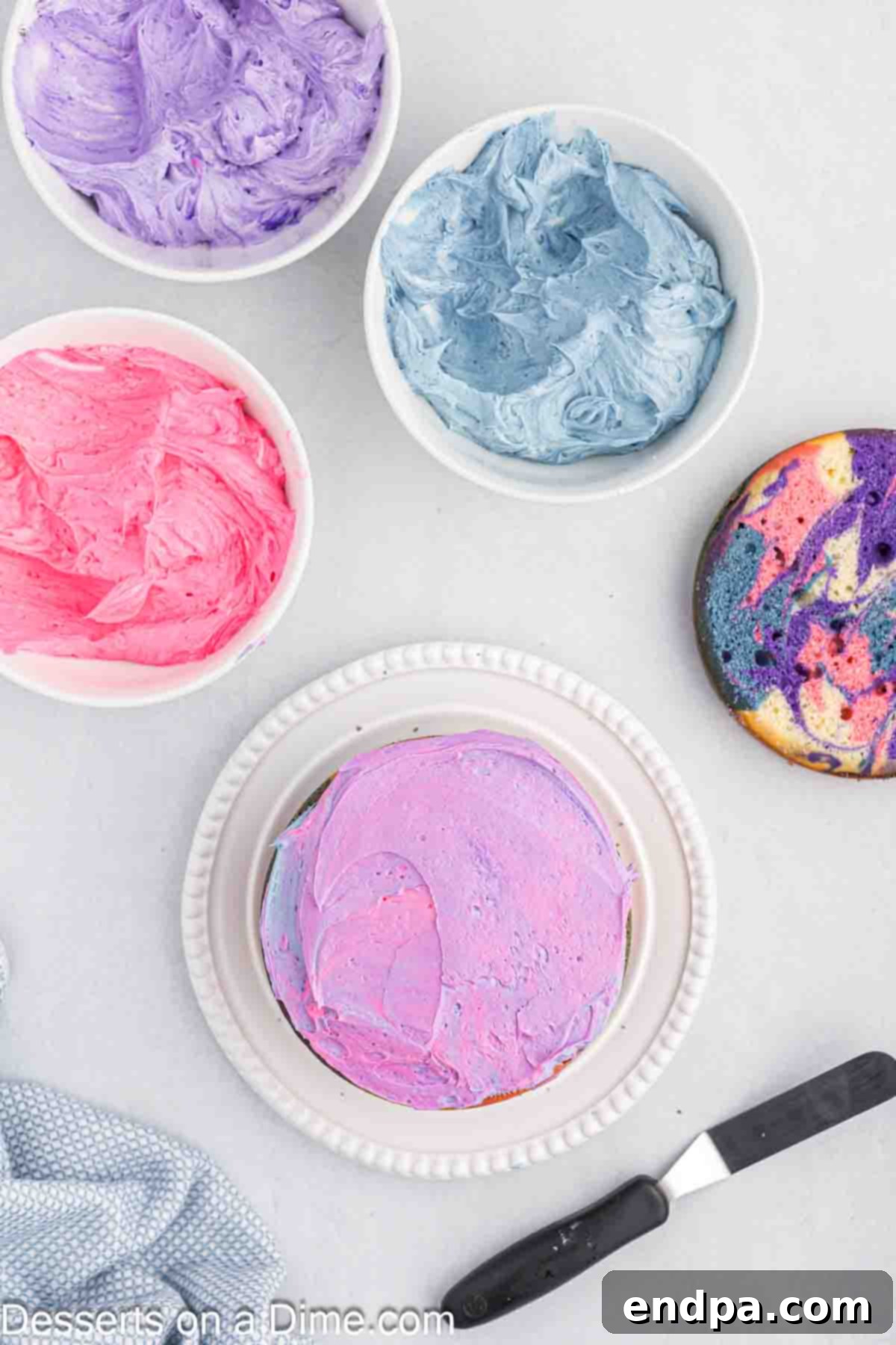 Crumb coat applied to the layered cake, sealing in loose crumbs.