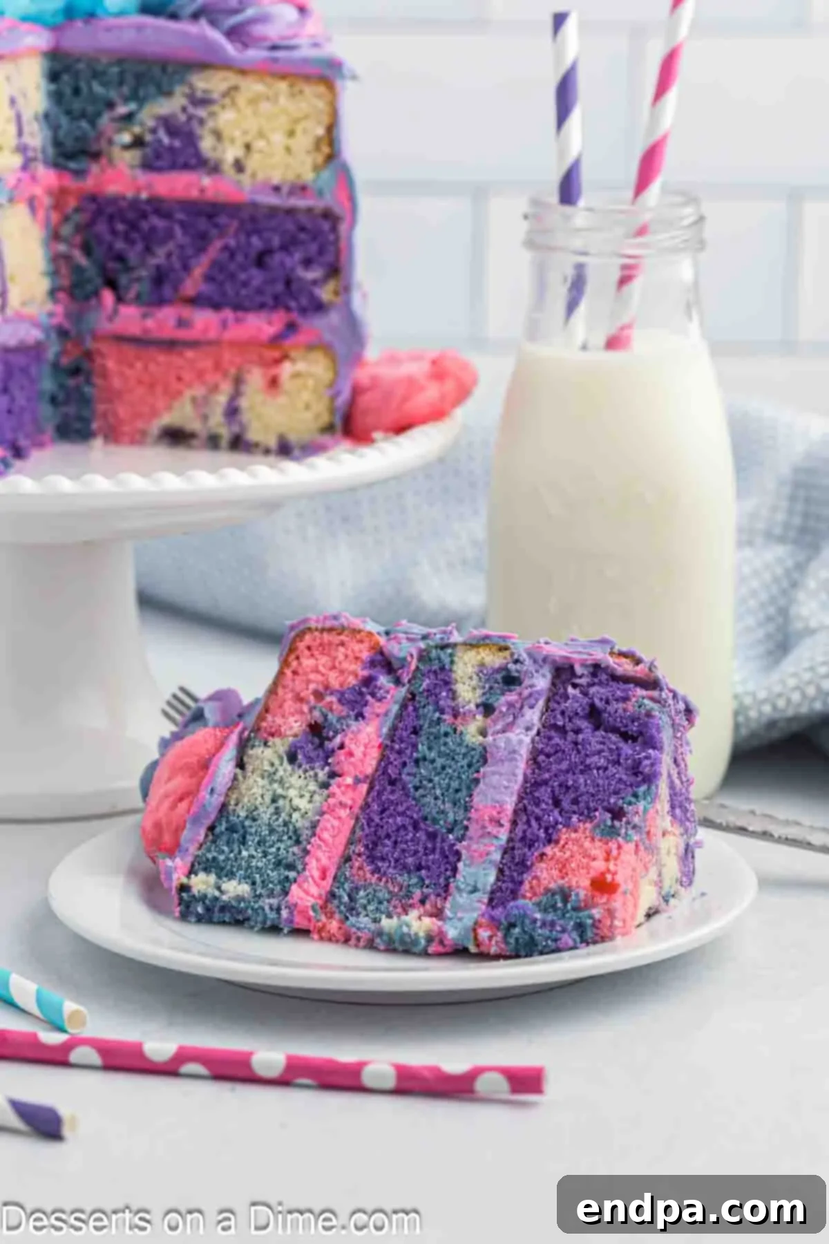 Slice of cotton candy cake on a white plate, showing the marbled layers and fluffy top.