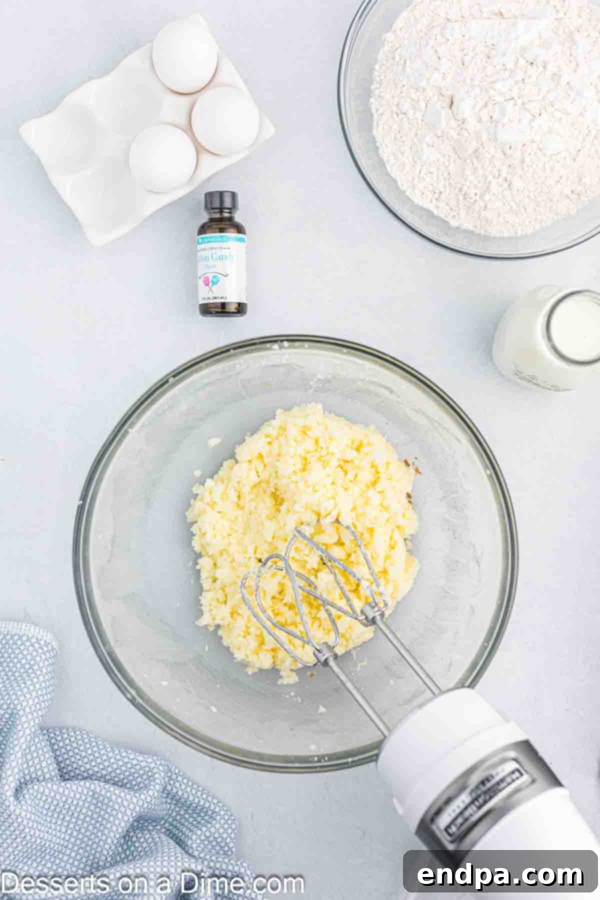 Butter and sugar creamed together in a mixing bowl.