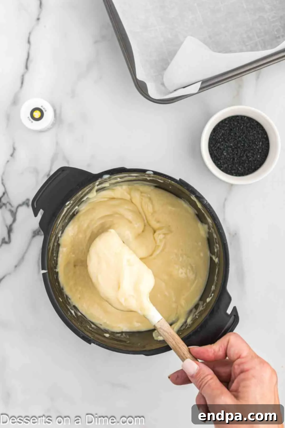 Naughty List Fudge 6 Fudge mixture being stirred until smooth and evenly combined with food coloring.