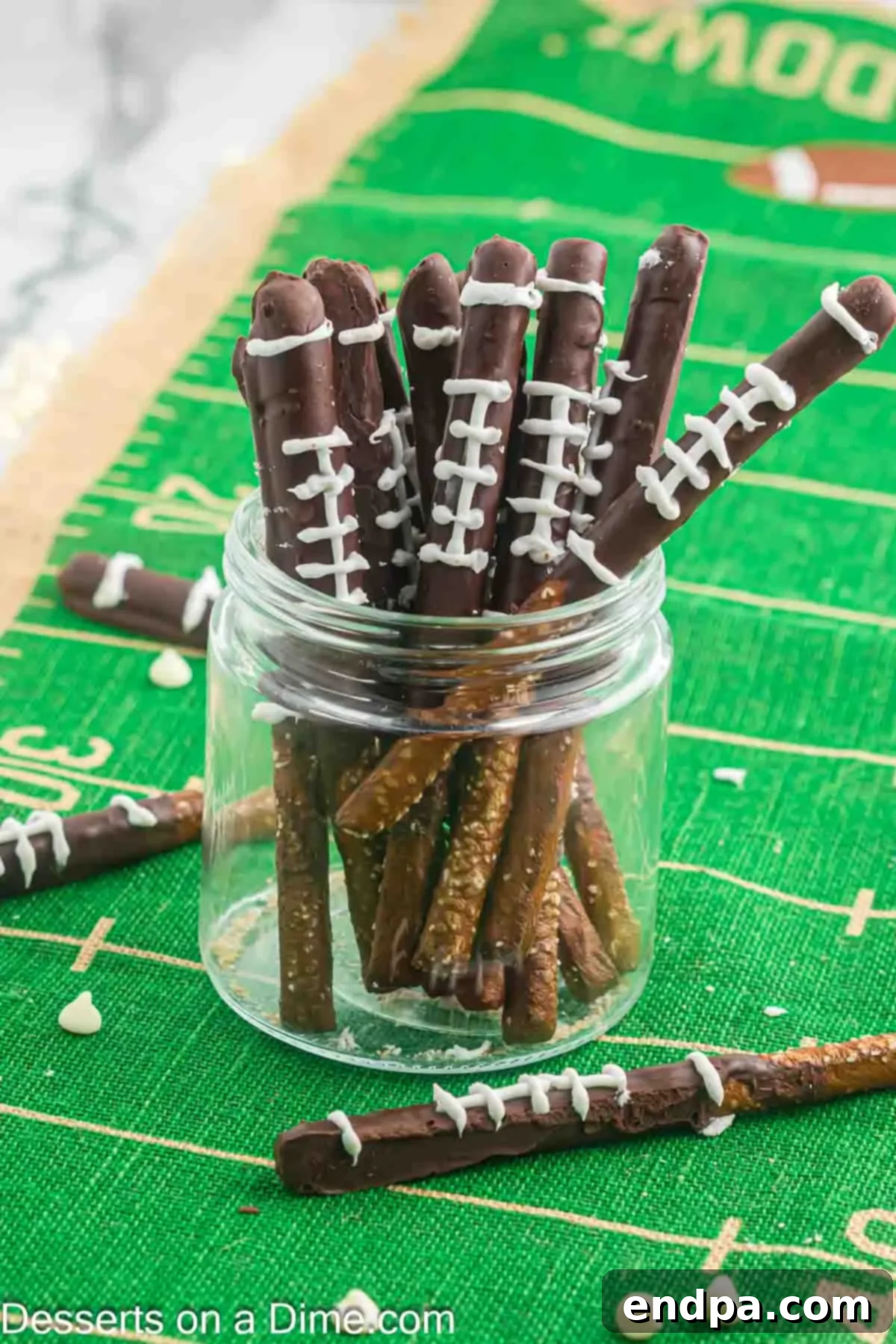 Touchdown Twists 9 Football Chocolate Covered Pretzel Rods in a glass jar