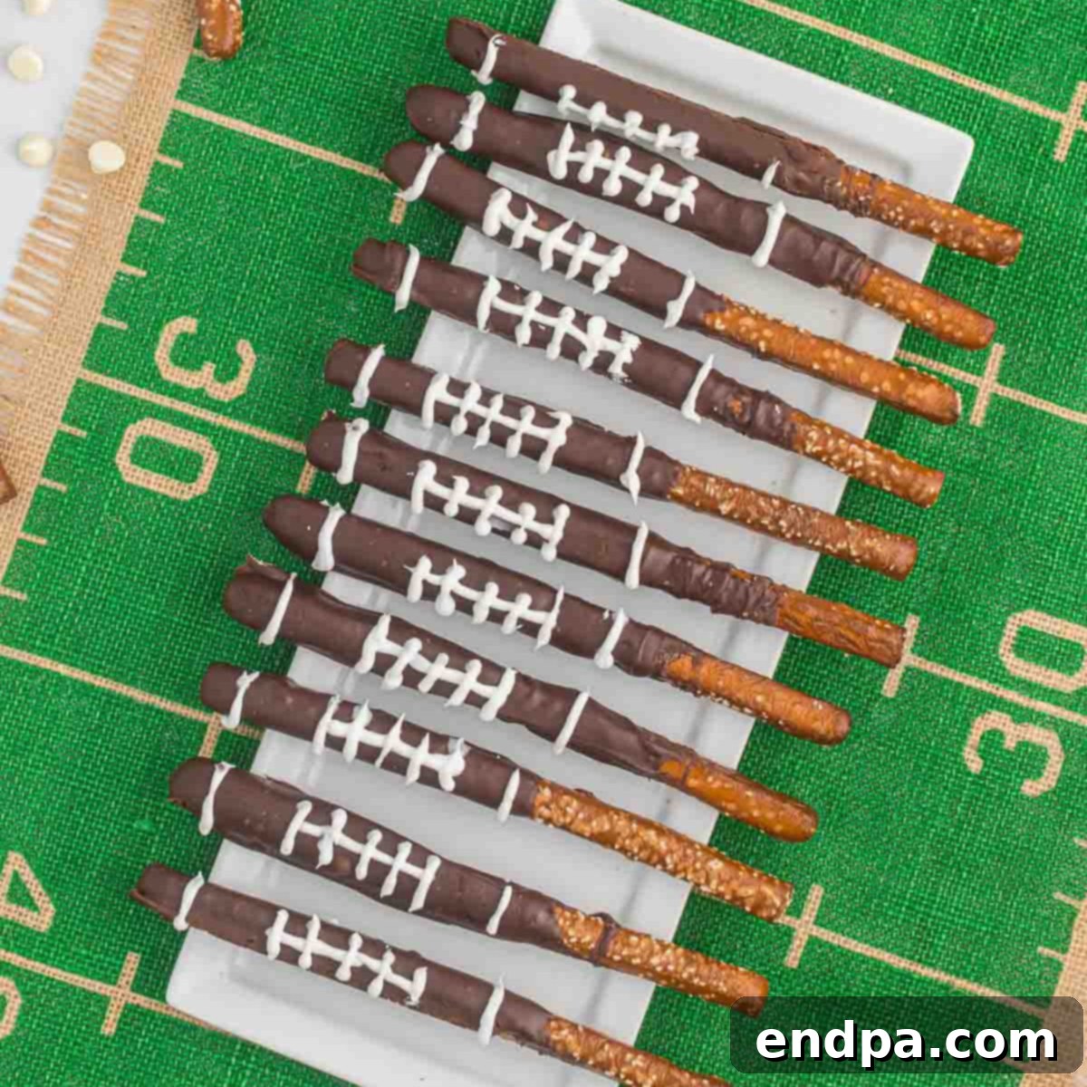 Touchdown Twists 10 Chocolate pretzels with football pretzels on a football field.