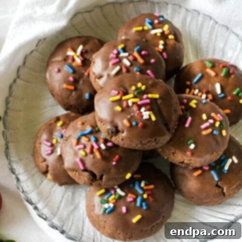 Chocolate cookies with sprinkles on a plate.