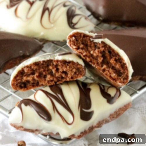 Chocolate covered cookies on a cooling rack.