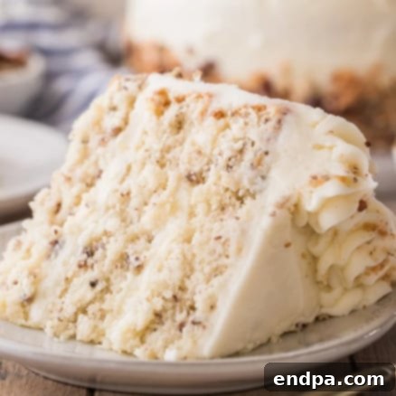 A slice of Italian Cream cake on a plate.