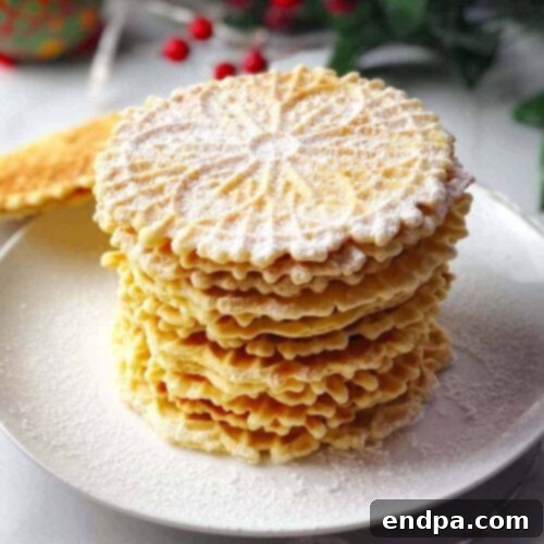 A stack of cookies on a plate with powdered sugar.