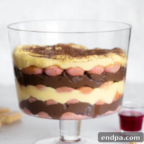 A trifle in a glass dish with chocolate and cream.