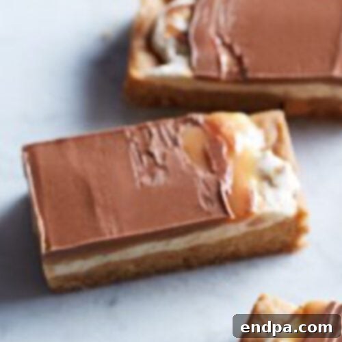 Four pieces of chocolate and peanut butter bars.