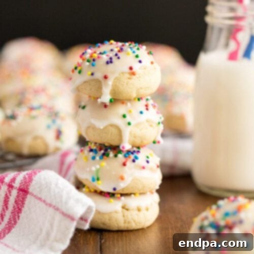 A stack of Anise cookies with frosting and sprinkles.