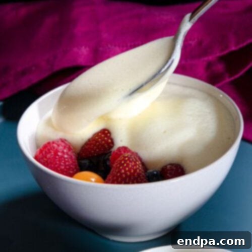 A bowl of yogurt with berries and fruit.