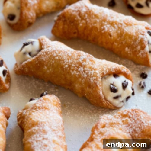 Cannoli's arranged together with powdered sugar.