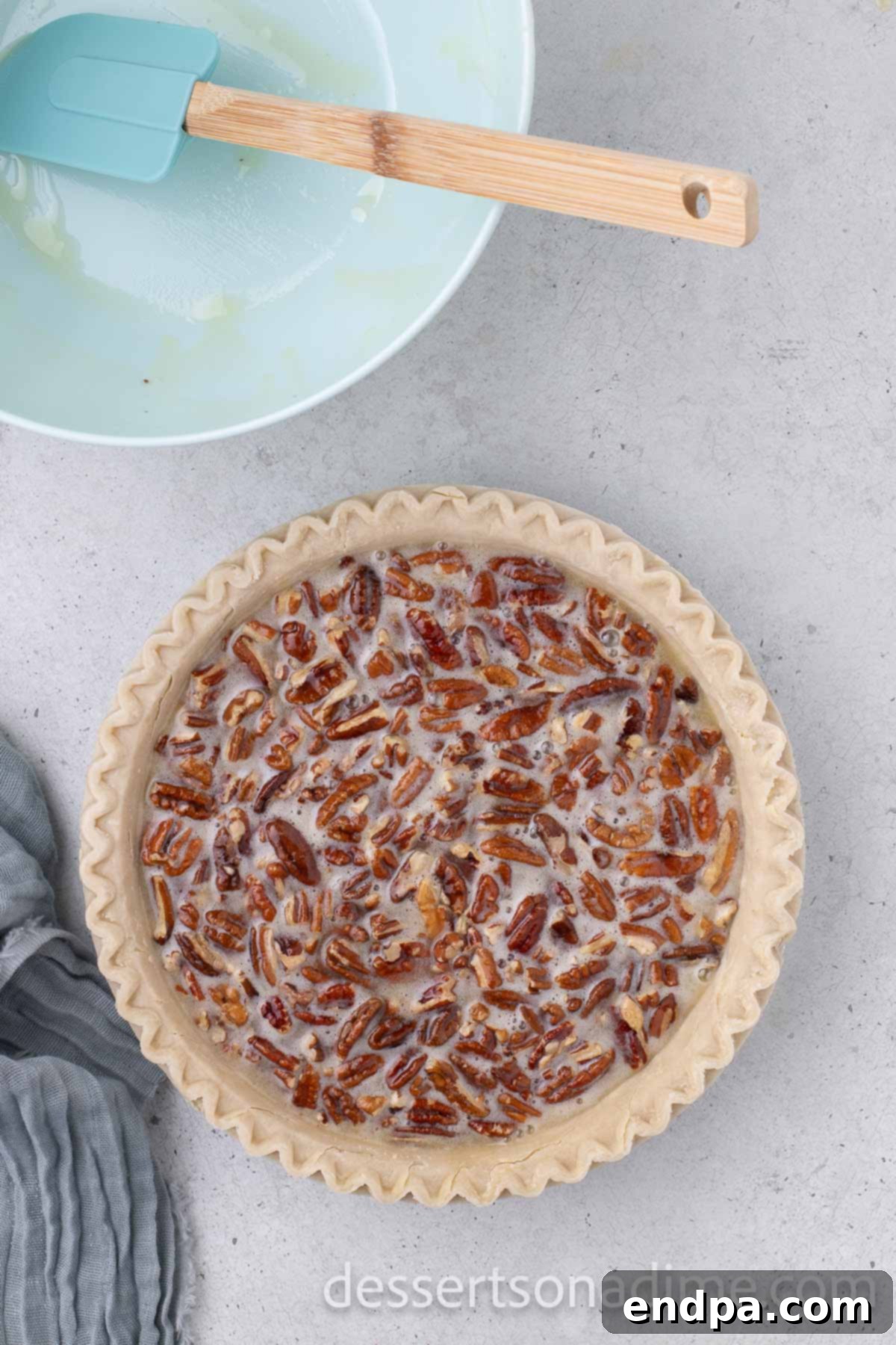The pecan pie mixture being carefully poured into an unbaked pie crust, ready for baking.