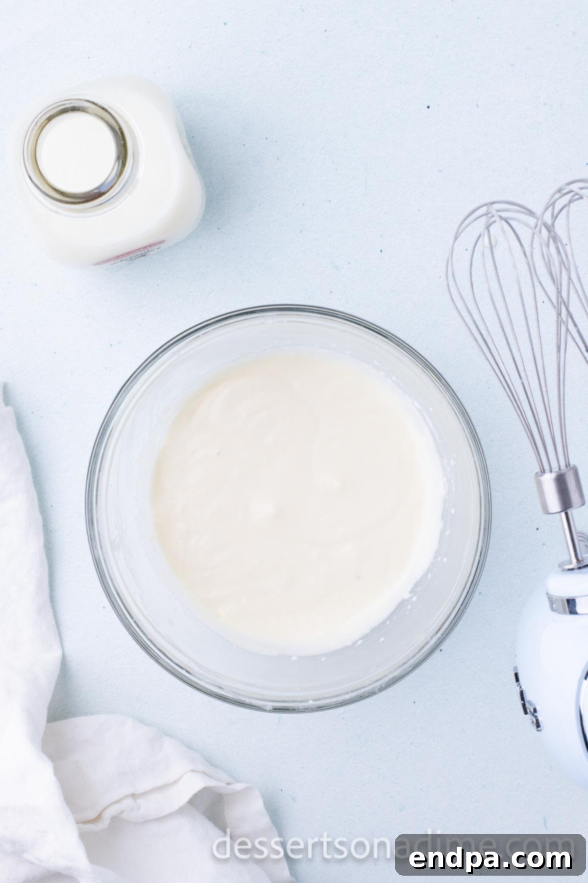 Step 4: A bowl of finished cream cheese glaze, ready for storage in the refrigerator before use.
