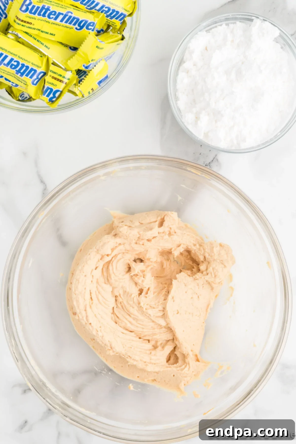 Decadent Butterfinger Crunch Pie 5 Powdered sugar mixed into the peanut butter mixture in a mixing bowl.