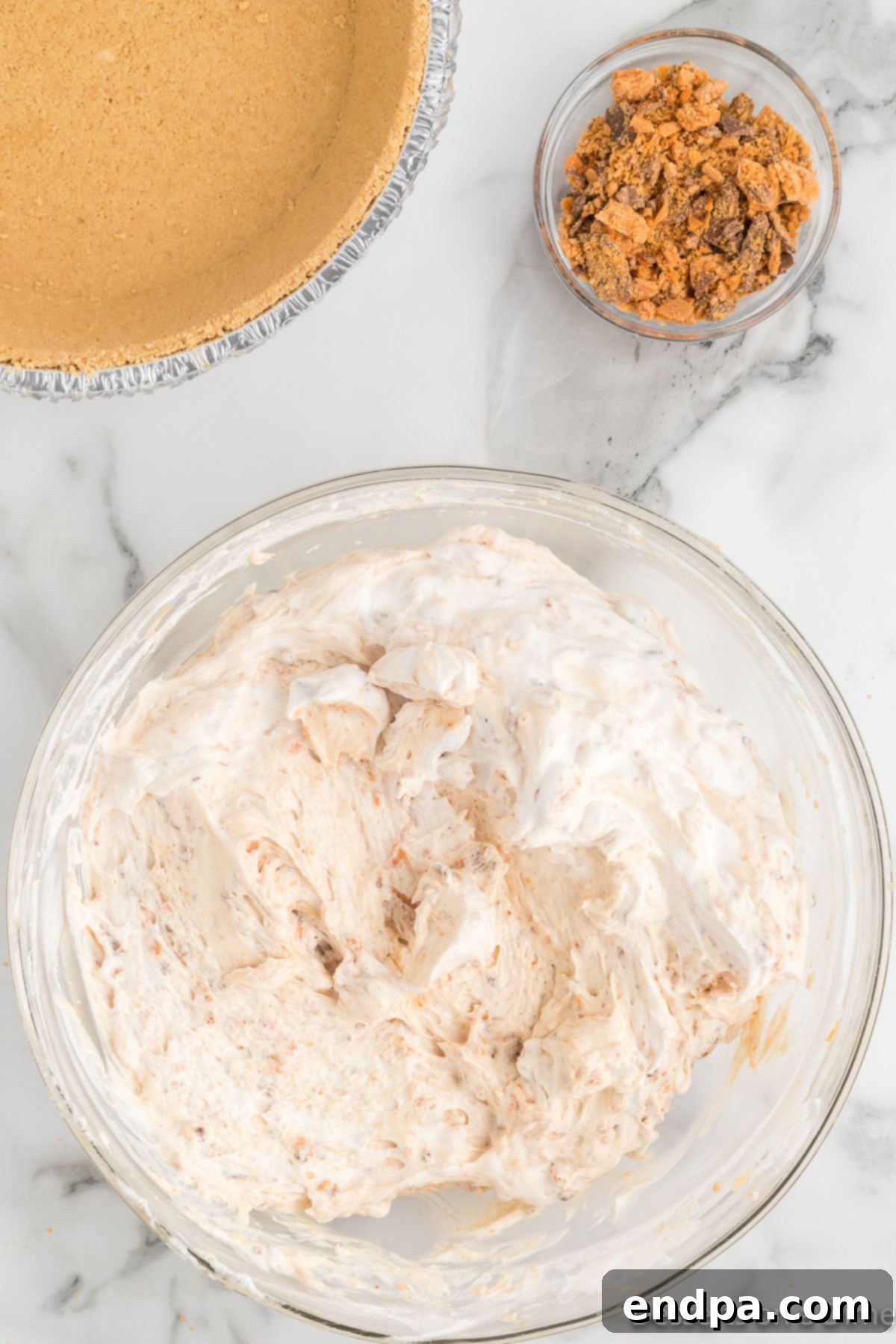 Decadent Butterfinger Crunch Pie 8 Bowl with whipped topping folded into the pie mixture.