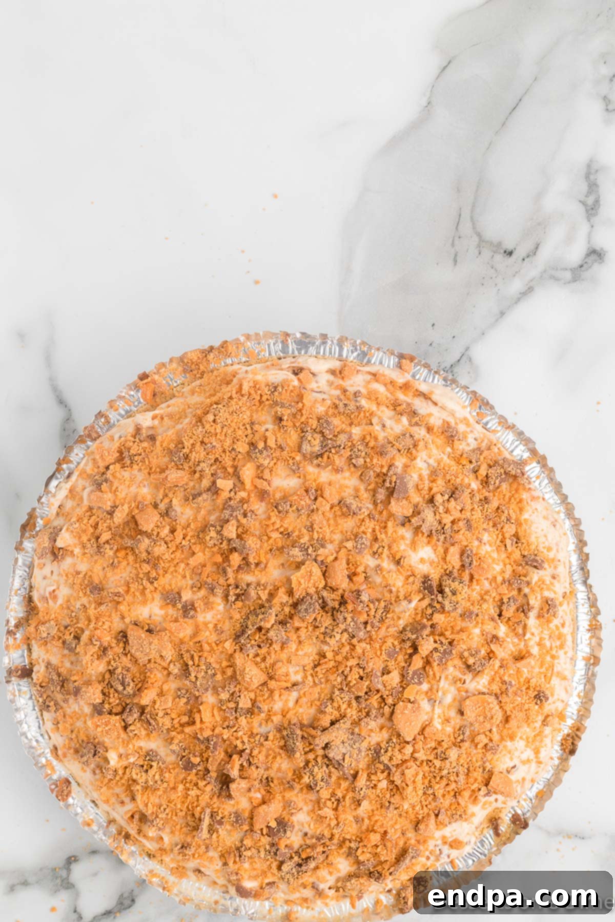 Decadent Butterfinger Crunch Pie 9 Pie topped with candy mixture.