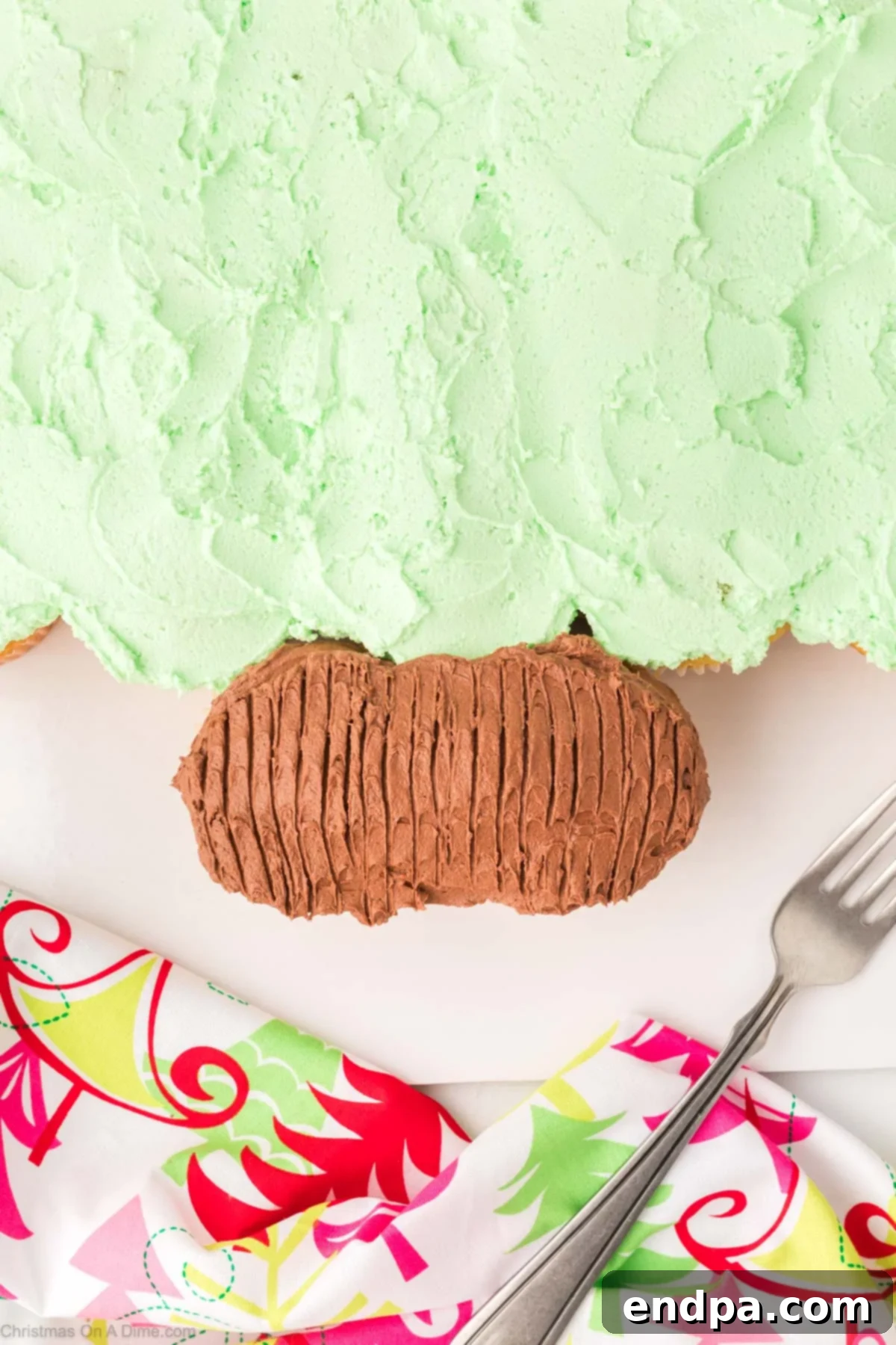 Brown frosting applied to the bottom cupcakes, textured with a fork to resemble a tree trunk.