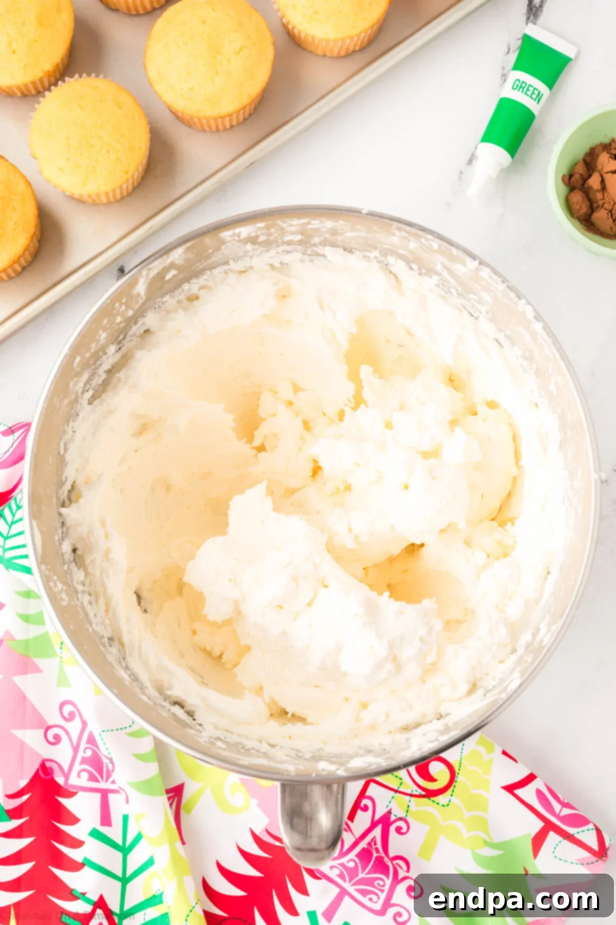 The frosting mixture becoming smooth after adding more powdered sugar.