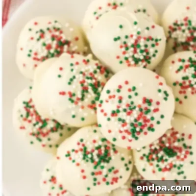 Sweet Yuletide Treasures 23 Christmas Truffles Recipe, rich and delicious, coated in white chocolate and festive sprinkles.