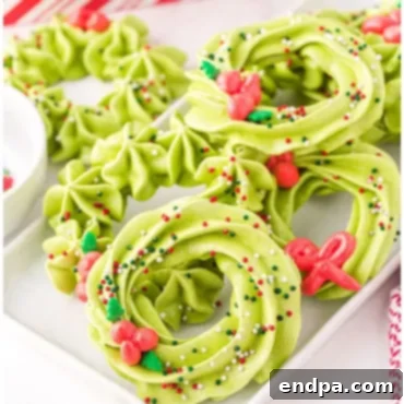 Sweet Yuletide Treasures 26 Meringue Wreath Cookies, a light, crisp, melt-in-your-mouth dessert made from egg whites, sugar, and lemon juice, perfect for Christmas.