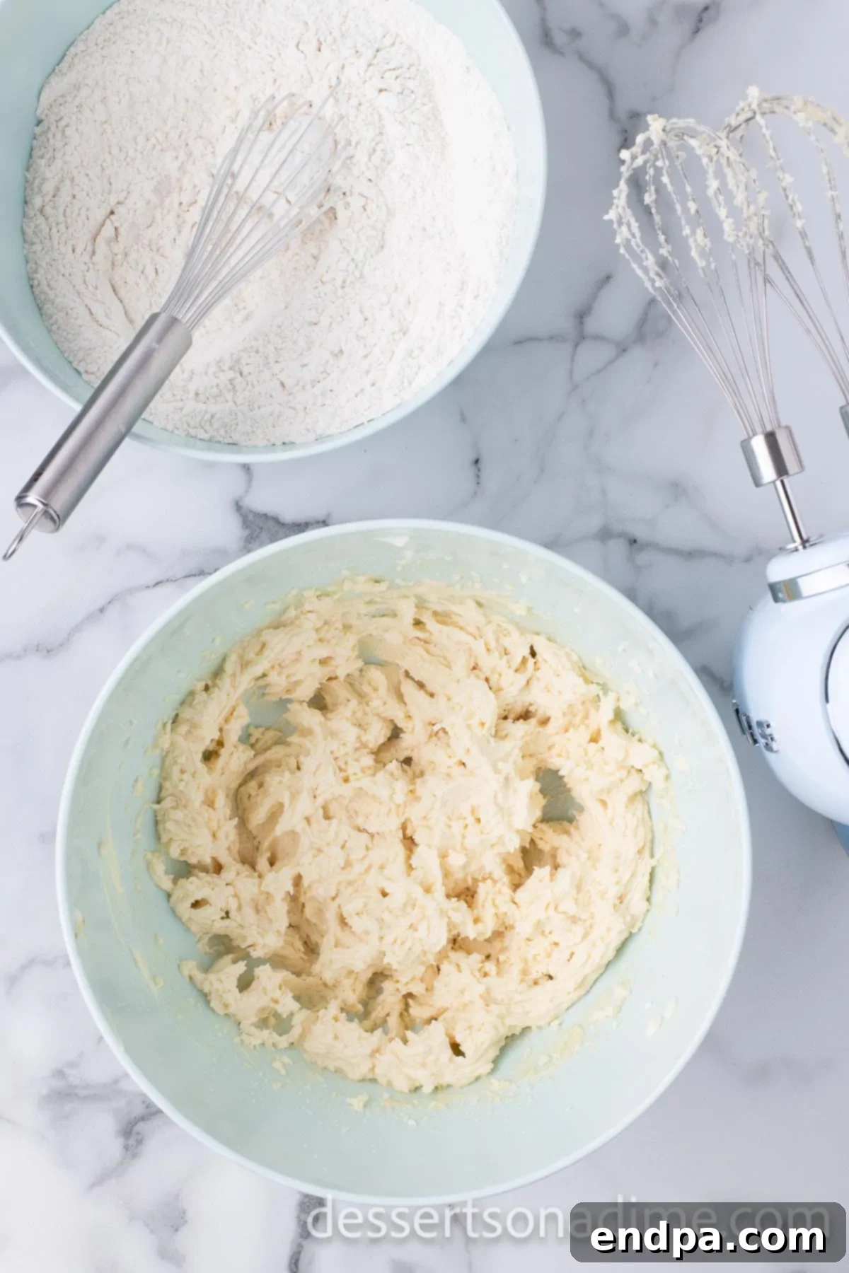 The mixing bowl now shows the wet and dry ingredients partially combined, with visible streaks of flour.