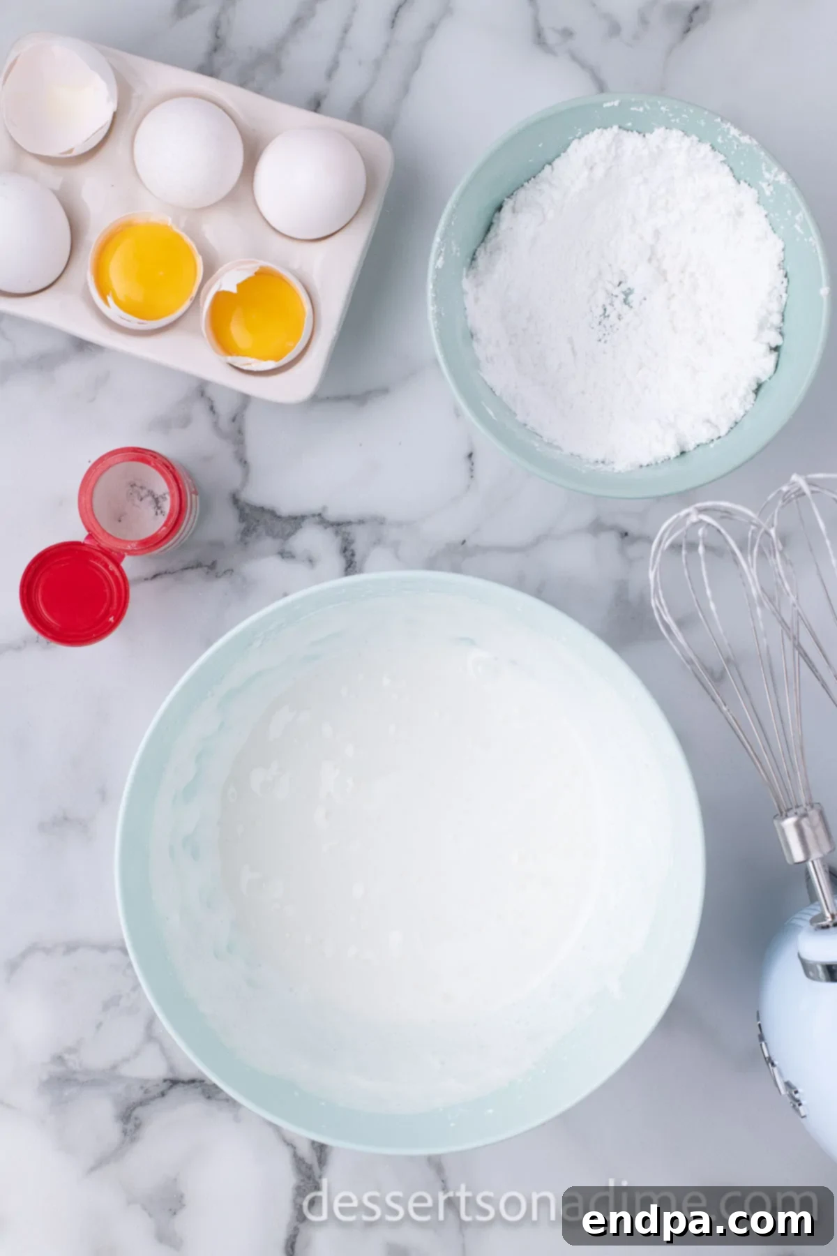 A mixing bowl filled with the smooth, white royal icing, ready for application.