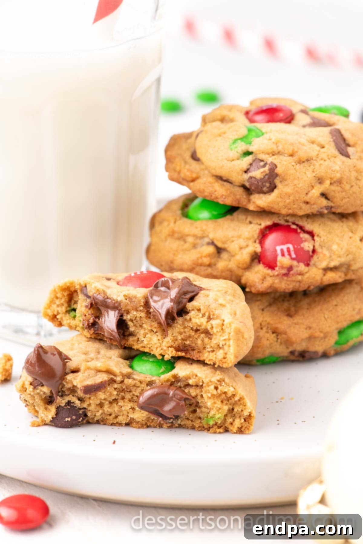 Stack of vibrant red and green M&M Christmas Cookies on a festive platter, ready for holiday celebrations.