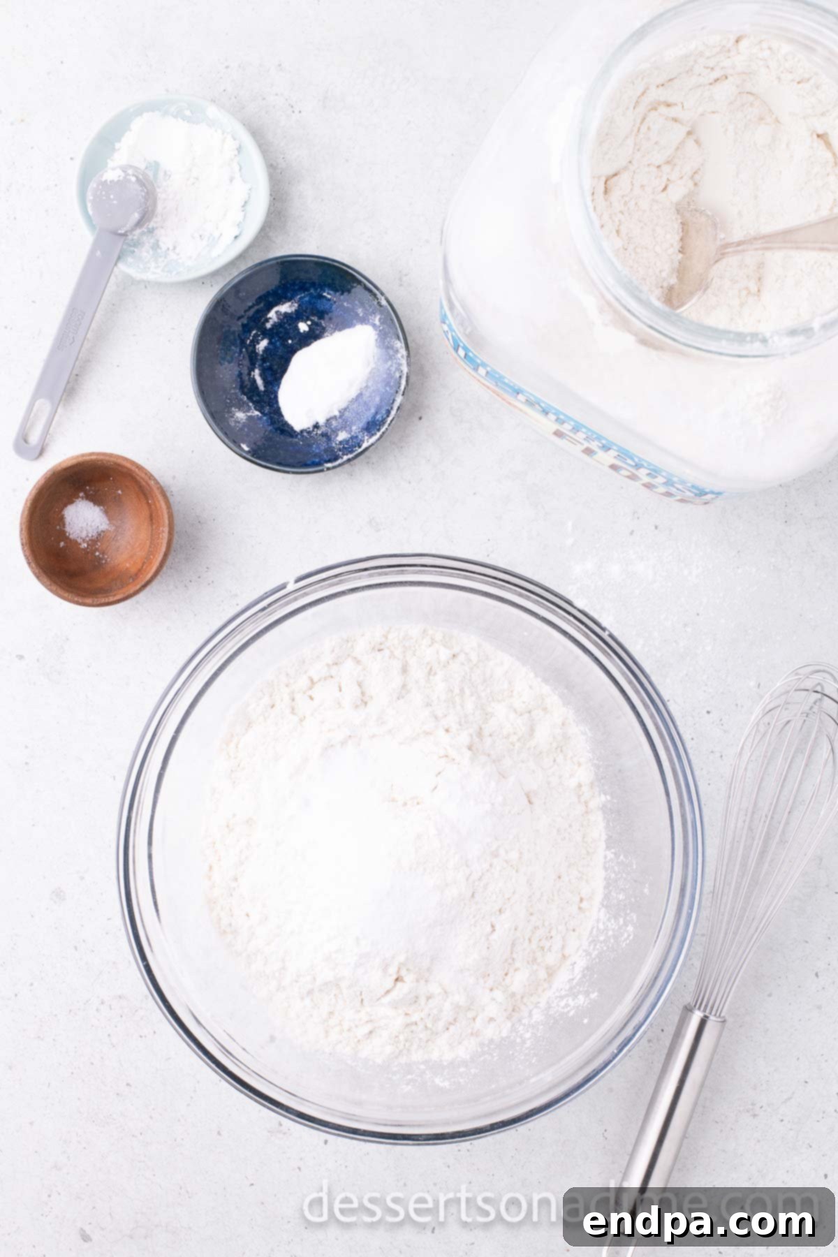 A separate bowl containing all-purpose flour, cornstarch, baking soda, and salt, ready to be combined.