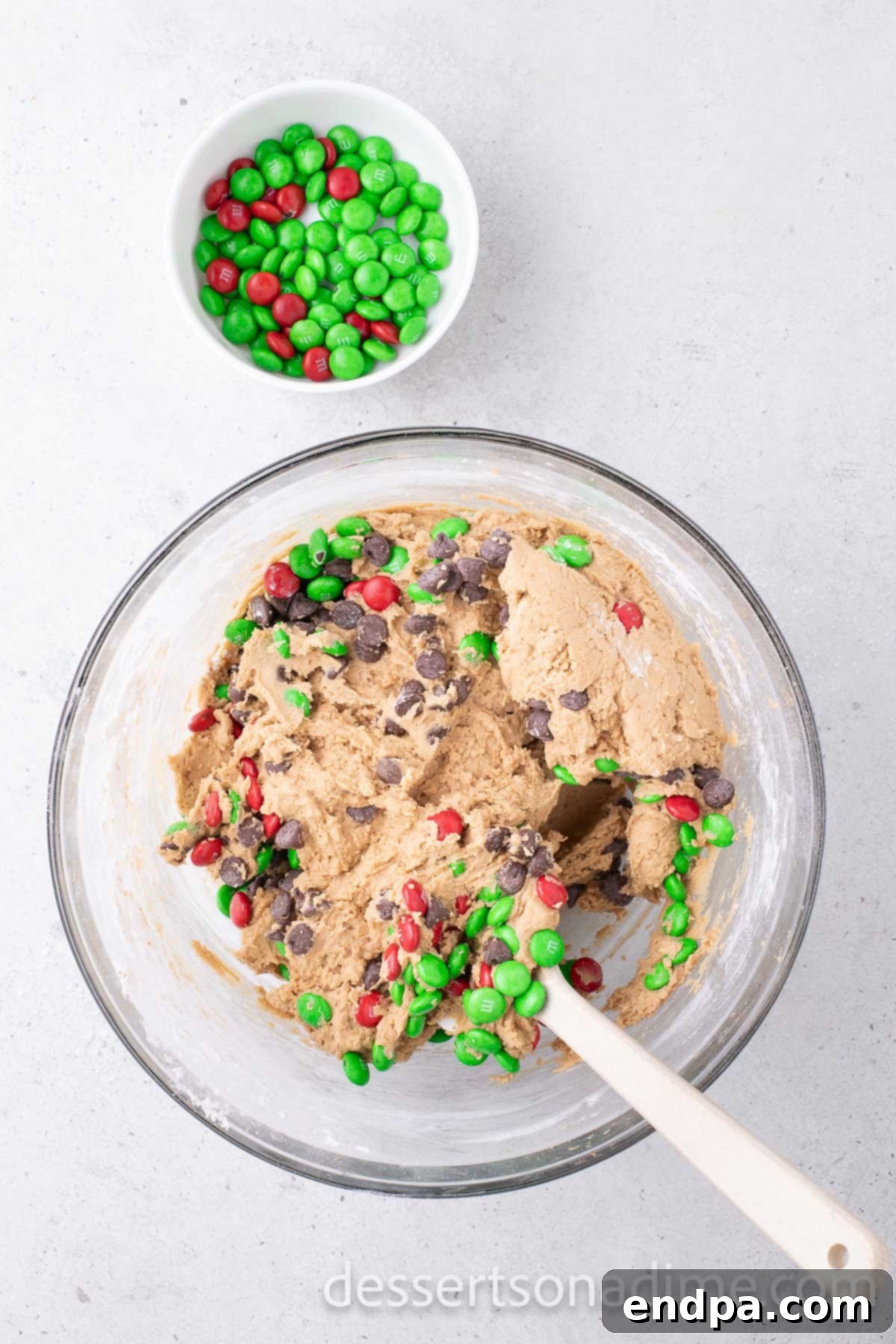 Cookie dough with chocolate chips and M&M candies gently folded in by hand.