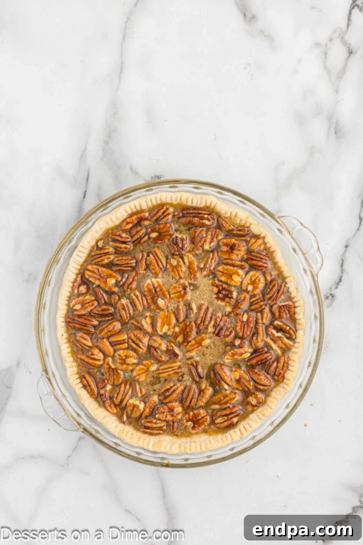 Paula Deen's Southern Comfort Pecan Pie 5 Pie filling mixture being poured into a pie plate.