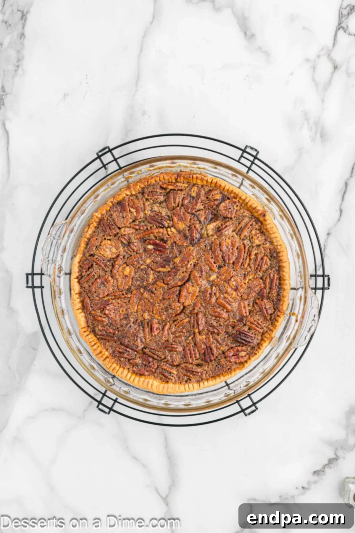 Paula Deen's Southern Comfort Pecan Pie 6 Pecan Pie cooling on a wire rack.