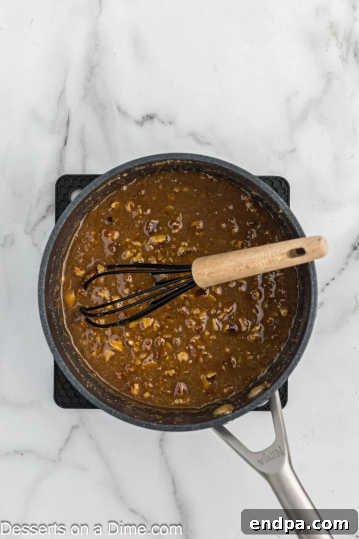 Paula Deen's Southern Comfort Pecan Pie 7 Pecan Caramel mixture combined in a pan.