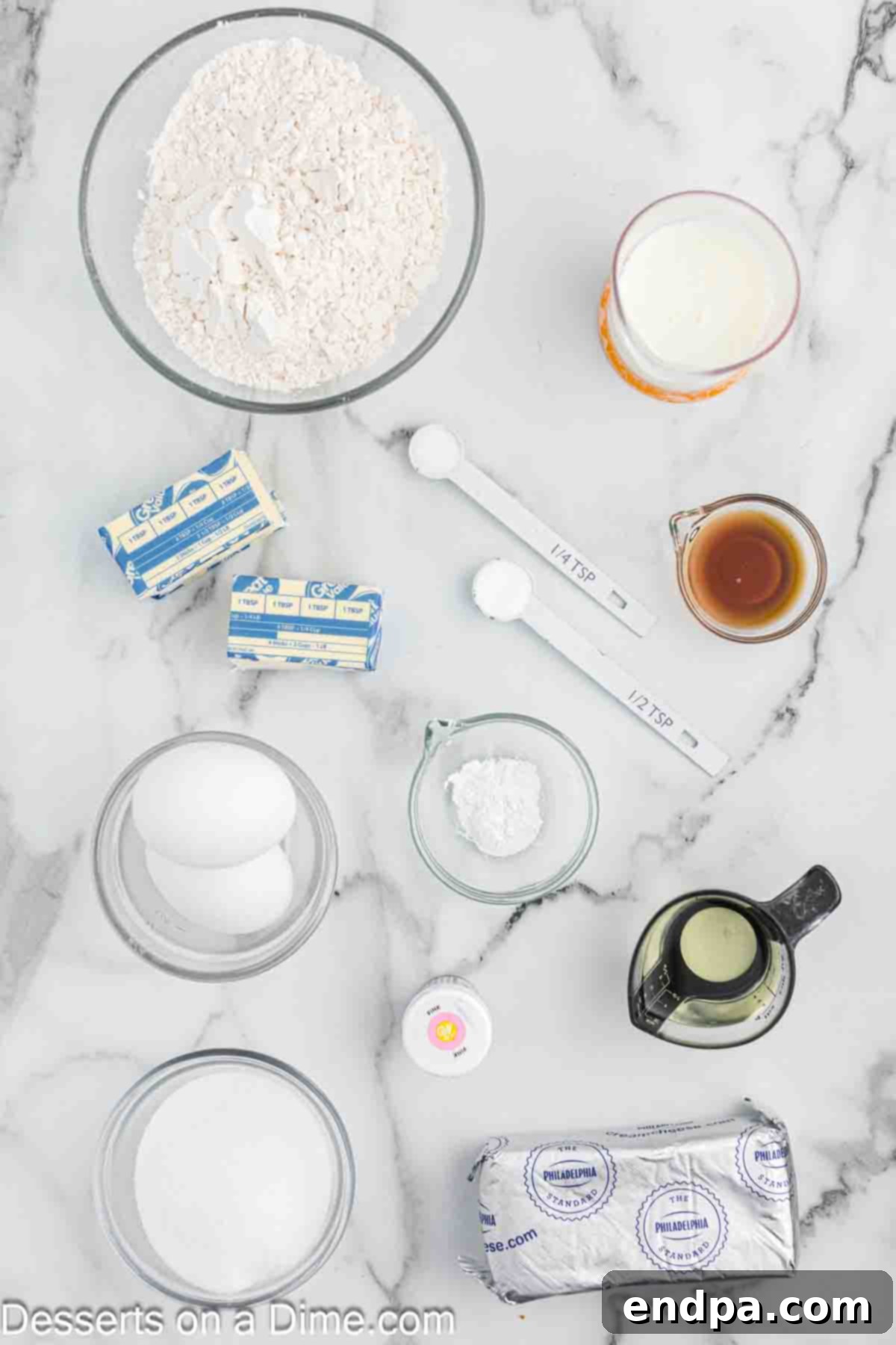 A flat lay image displaying the key ingredients for pink velvet cupcakes: flour, butter, sugar, vegetable oil, eggs, buttermilk, pink food coloring, cream cheese, and vanilla extract.