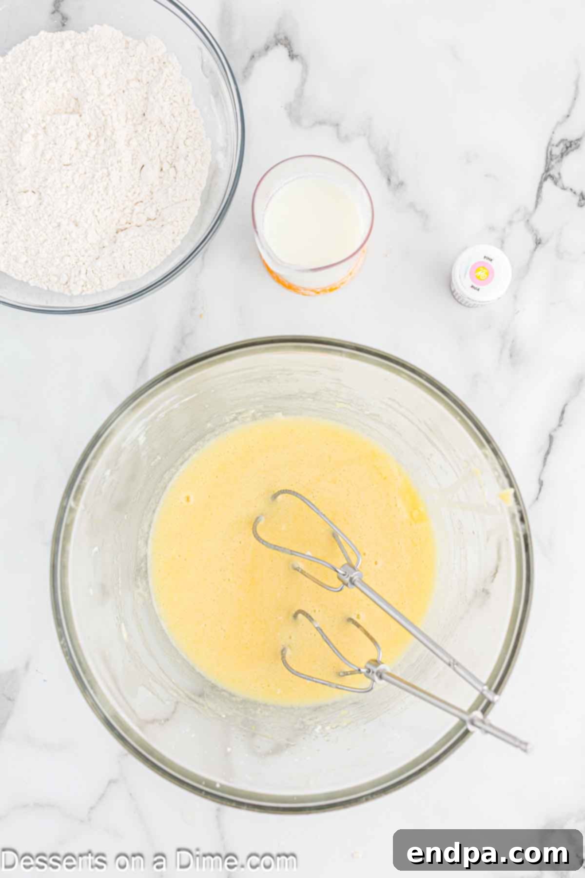 Eggs, vegetable oil, and vanilla extract added to the butter and sugar mixture in a mixing bowl.
